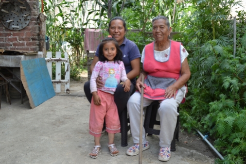 Severa Galicia Flores (right) sits in her front garden with her daughter Elena Hernández Galicia and granddaughter Melissa Fuentes Hernández
